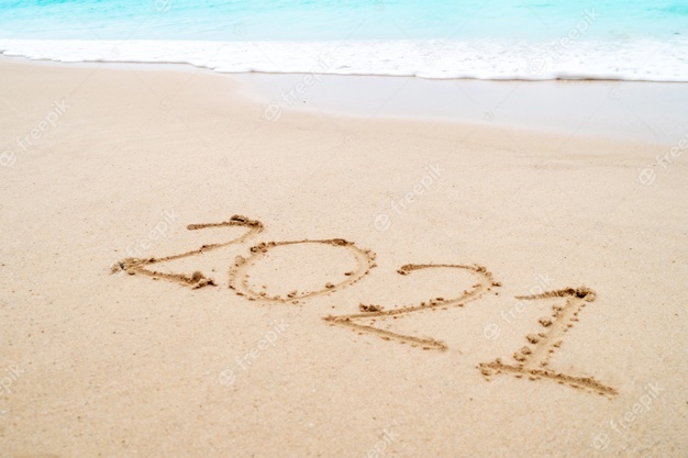 Photo of 2021 written in sand